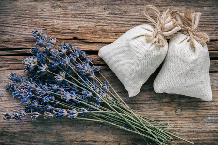 Bouquet of dry lavender flowers and sachets filled with dried lavender. Top view. Flat lay. Retro toned.の写真素材