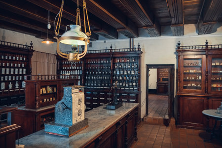Kaunas, Lithuania - May 12, 2017: Interior of old pharmacy: shelfs with drugs, apothecary scale and vintage cash register in Museum of the History of Medicine and Pharmacy.のeditorial素材