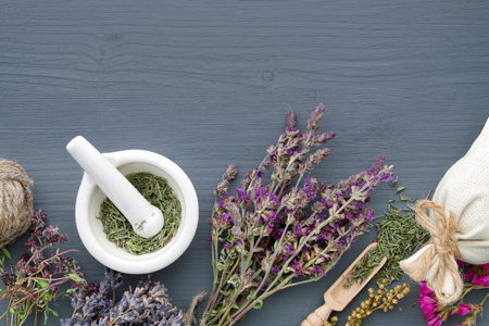 Bunches of healing herbs, mortar and sachet on board. Herbal medicine. Copy space for text. Top view, flat lay.の写真素材