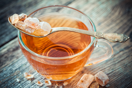 Tea cup and caramelized cane sugar in spoon.の写真素材
