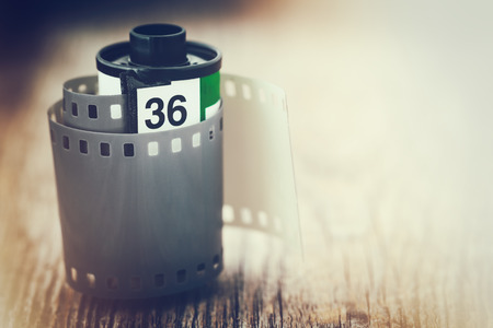 Old photo film cassette. Retro stylized photo with a glow effect. Copy space for text.の写真素材