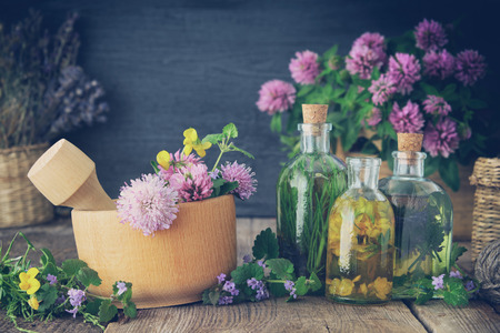 Bottles of tincture or infusion of healthy herbs, healing herbs on table. Herbal medicine.の写真素材