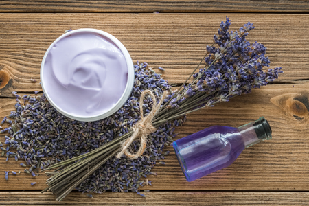 Lavender cream or balm, essential oil, mortar of dry lavender and bunch of dried flowers. Top view, flat lay. の写真素材