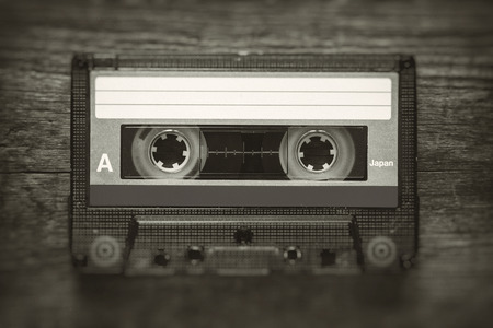 Retro stylized photo of vintage Audio cassette tape with blur and noise effect.の写真素材
