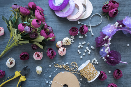 Making a artificial flowers and wreath for wedding decorating. Tools and accessories for creating on table, top view, flat lay.の写真素材