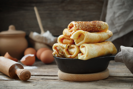 Frying pan of freshly baked pancakes,  Ingredients and kitchenware for pancakes making.の写真素材