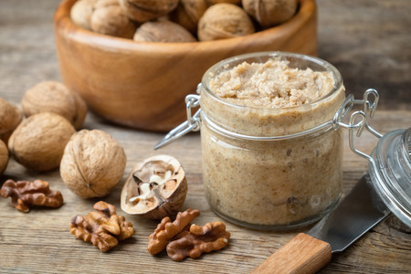 Raw organic walnut butter and fresh nuts.の写真素材