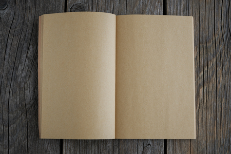 Open old empty book on wooden board.の写真素材