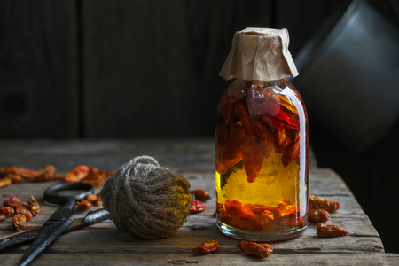 Bottle of red chili pepper infusion or oil.の写真素材