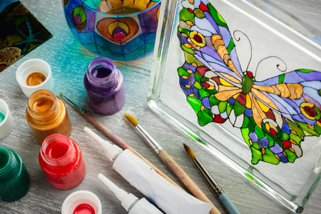 Artisan painting with stained glass paints on a glass.の写真素材