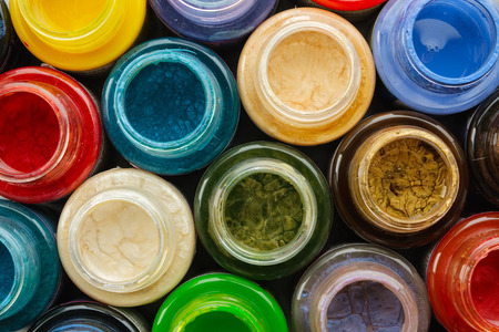 Colorful stained glass paints or oil, acrylic paints close up, top view.の写真素材