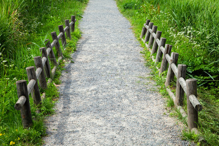 Walking path with a wooden fence.の写真素材