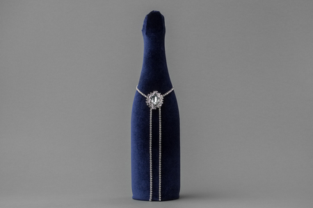 Decorated with velvet wedding champagne bottle on grayの写真素材
