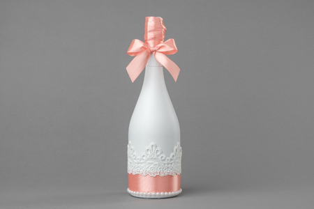 Wedding champagne bottle decorated with lace and ribbon.の写真素材