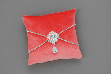 Wedding Pillow for Rings decorated with jewel. Luxury velvet pillow in coral color.の写真素材