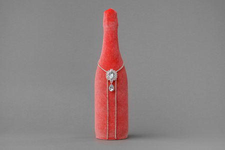 Wedding champagne bottle Decorated with velvet in coral color.の写真素材