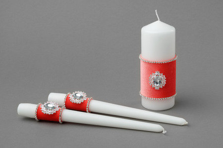 Beautiful candles decorated with coral velvet cloth.の写真素材