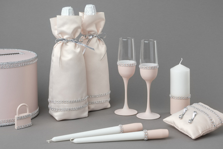 Wedding accessories: bottles of champagne in bags, wine glasses, candles, box for money and wishes, wedding lock and pillow for rings.の写真素材