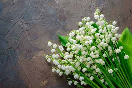 Lilies of the valley bouquet on dark brownの写真素材