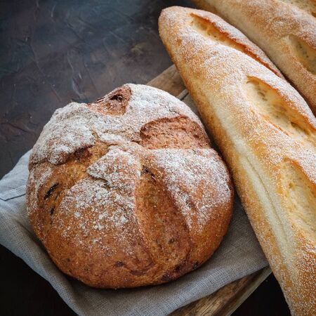 Freshly baked baguettes and bread on a linen napkin. Top view.の写真素材