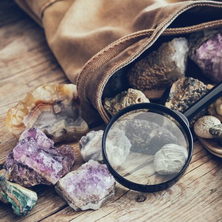 Mineral stones: turquoise, morion, smoky quartz, rhinestone, chalcedony, fluorite, agate, amethyst, onyx, chalcedony and magnifying glass and backpack of geologist.の写真素材