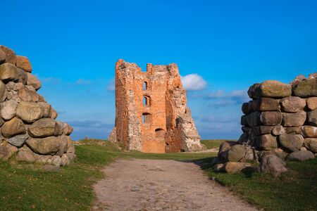 Ruins of Tower Shchitovka and Mindovg Castle, boulder fence in foreground.の写真素材