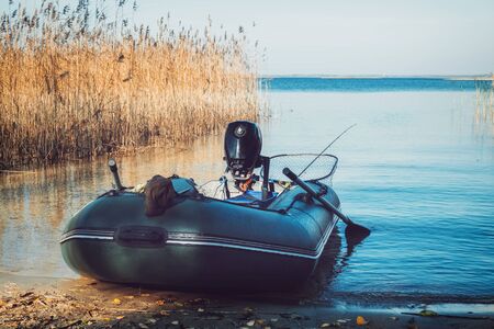 Rubber fishing boat on a tranquil lake shore.の写真素材