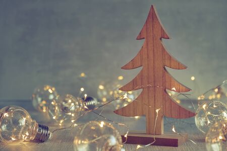 Wooden christmas tree and christmas light bulbs.  Greeting card.の写真素材