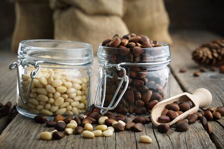 Pine nuts. Jars and bags of cedar pine nuts.の写真素材