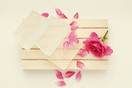 Soap bar and rose flower on wooden pallet.の写真素材