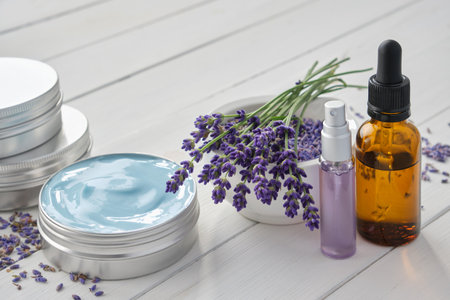 Natural lavender cream, bunch of lavender flowers, dropper bottle of essential lavender oil and perfumed water or hydrolate in a spray bottle.の写真素材