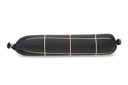 Traditional salami sausage in a black wrapper on white background.の写真素材