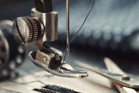 Close up of sewing needle. Tailoring scissors on working part of antique sewing machine.の写真素材