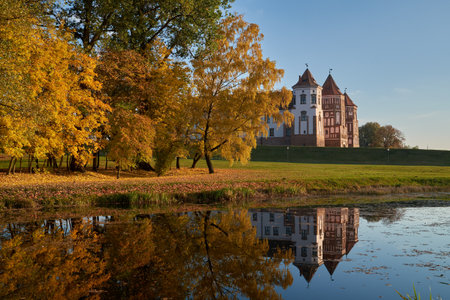 Autumn park with pond and old medieval castle in Mir township, Grodno region, Belarus.のeditorial素材