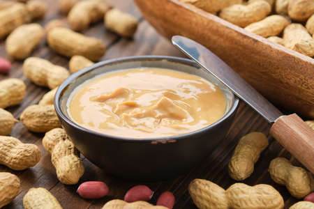 Bowl of peanut paste and fresh nuts.