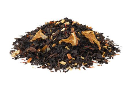 Pile of dry black tea leaves on white. Heap of aromatic black tea leaves with dried citrus slices and peel.の写真素材