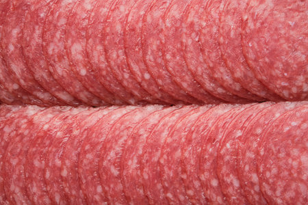 Chopped salami sausage, top view, flat lay.の写真素材