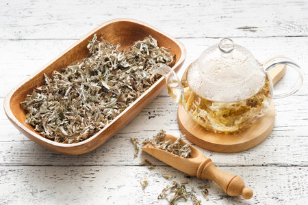 Glass teapot of herbal Icelandic moss tea. Wooden scoop and bowl dried of Iceland moss. Cetraria islandica - latin name of plant. alternative herbal medicine.の写真素材