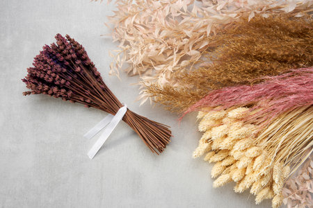 A tied bundle of dried lavender. Dried plants, flowers and spikelets for decorative bouquets and interior design. top view.の写真素材