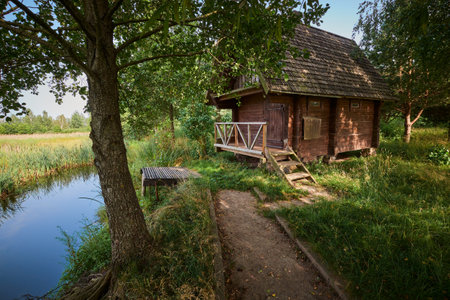 Bath house on the shore of the pond in summer.の写真素材