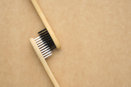 Two eco-friendly wooden bamboo toothbrushes. living together. love concept. A conceptual of a couple toothbrushes in love.の写真素材