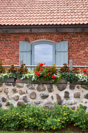 Vintage window and balcony decorated with Geranium and other flowers.の写真素材