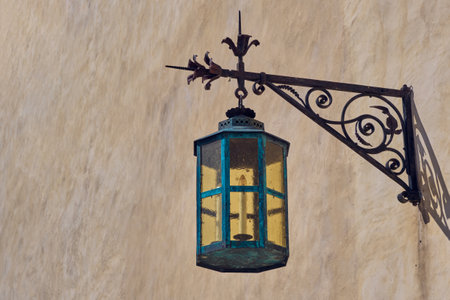 Vintage forged street lamp on wallの写真素材