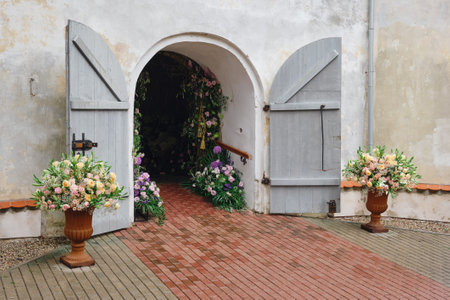 The entrance to the building is beautifully and elegantly decorated with flowers for the holiday. Open doors to the church for the wedding ceremony.の写真素材