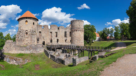 Latvian tourist landmark attraction - ruins of the medieval Livonian castle, stone walls and towers  in old Cesis town, Latvia.のeditorial素材