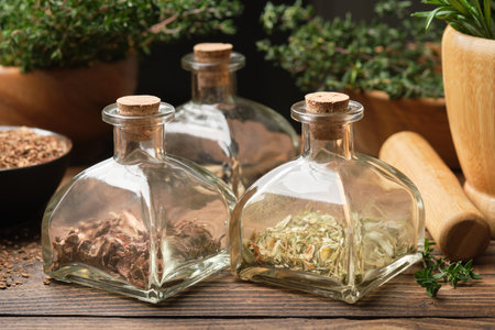 Bottles of dry herbs for preparing healing infusions or tinctures. Medicinal plants on background. Alternative herbal medicine.の写真素材