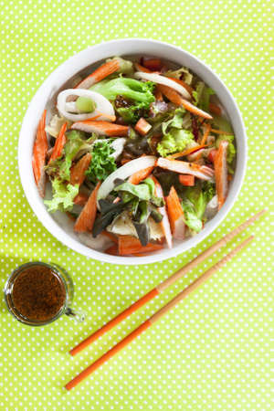 Crab stick salad on green polka dots background の写真素材