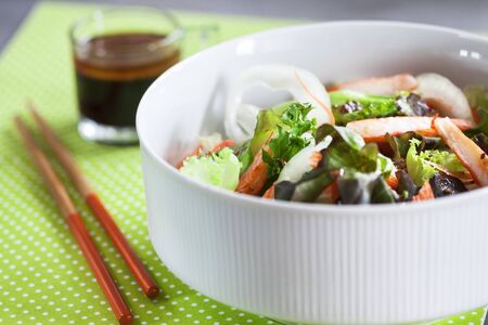 Crab stick salad on green polka dots background の写真素材