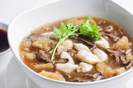 Braised Fish Maw in Red Gravy with crab in bowl の写真素材