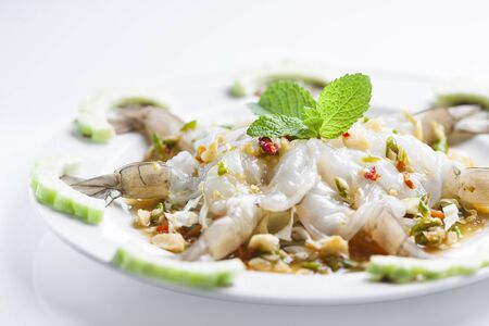 Raw Shrimp with chili sauce on white background の写真素材